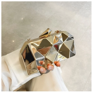 Macro view of geometric multifaceted acrylic evening clutch with metallic snap closure