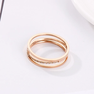 Macro detail of rose gold triple-layer ring with sparkling pave cubic zirconia accents