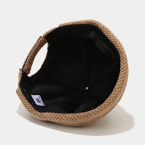 Inside view of a retro brown knit beanie cap with soft black lining and brand label