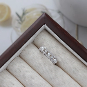 Silver wavy open ring with pearls and pavé zircons in a premium jewelry box setting