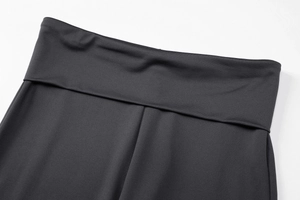 Detailed close-up of high-waist black yoga pants featuring premium fold-over waistband stitching