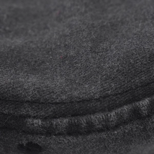 Macro shot of washed gray baseball cap showing fabric texture and double-row stitching
