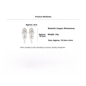 Détails des boucles d'oreilles à pompons argentés de 10,5 cm sur 4 cm et pesant 33 g
