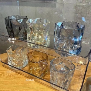 Macro view of six colorful irregular origami whiskey glasses with ice crack textures