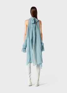 Detail of elegant light blue chiffon top featuring a back bow tie and long ribbons