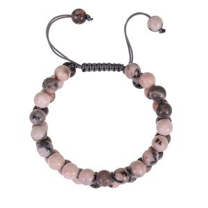 Close-up of pink zebra stone beads and gray braided cord on an adjustable bracelet