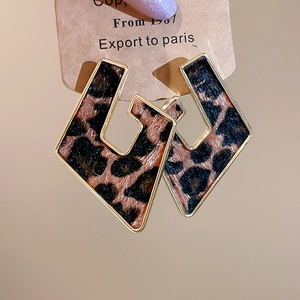 Close-up of leopard print hollow geometric earrings with gold-plated metal borders
