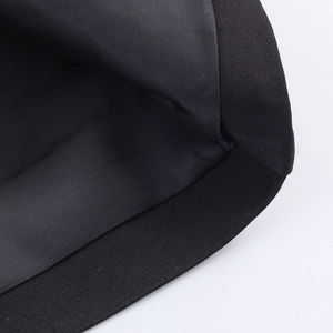 Detailed view of the woven fabric texture and stitching on a black long fur coat