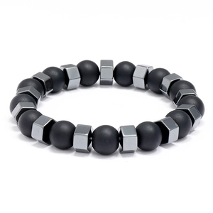 Unisex matte black onyx beads bracelet with geometric metallic spacers on white background