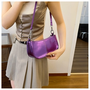 Detail of purple metallic PU underarm bag with sleek rectangular shape and matching strap