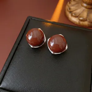 Elegant silver stud earrings with polished deep red agate beads in a minimalist retro style