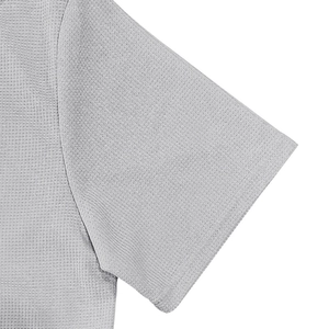 Primer plano de la textura de punto tipo gofre gris y detalles de costura del polo