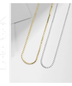 Detail of minimalist S925 silver and gold choker necklace with metallic bead chains