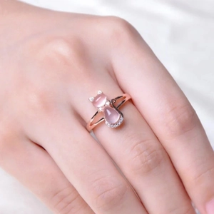 Elegant rose gold cat ring with pink gemstones and white zircons on a model hand