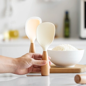 Standing silicone rice paddle with heat-resistant wooden handle and non-stick texture