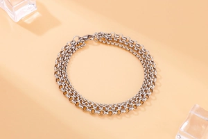 Detail of silver triple-layer stainless steel chain bracelet with secure lobster clasp