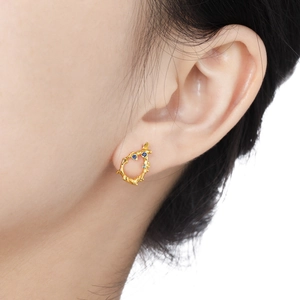 Irregular gold lava stud earrings with blue gems and S925 silver finish on model