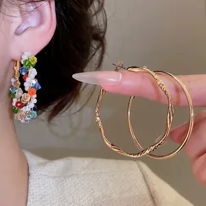 Colorful crystal bead and pearl wrapped round earrings with golden textured hoop design