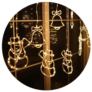 Warm white LED curtain string lights featuring snowman and bell charms for window decor