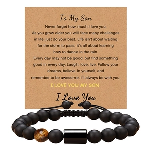 Detail of matte black beads and tiger eye stone bracelet with To My Son message card