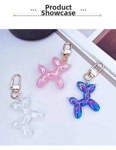 Detail of colorful metallic balloon dog keychains with golden lobster clasps in pink and blue