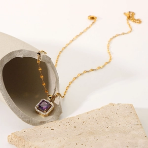 Detailed macro view of 18k gold-plated chain with square purple zircon pendant for women