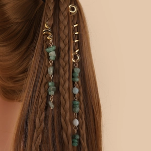 Ethnic hair rings with natural green stones and gold spiral charms on braided hair
