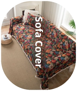 Detailed view of woven floral sofa blanket featuring colorful patterns and white fringe edge