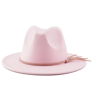 Close-up of light pink fedora hat with woven band detail and tassel accent in felt texture