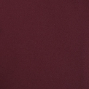 Close-up of deep red twill fabric texture showing fine weave details of the dress material