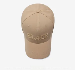 Top view of khaki baseball cap featuring 3D gold 'BLACK' embroidery on cotton fabric