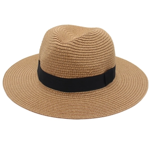 Detailed close-up of woven straw texture and black ribbon band on a Panama jazz hat