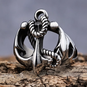 Vintage silver anchor and rope stainless steel ring on a rustic wood bark base