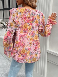Detail showing the elegant ruffled back design of a pink floral long sleeve shirt for women