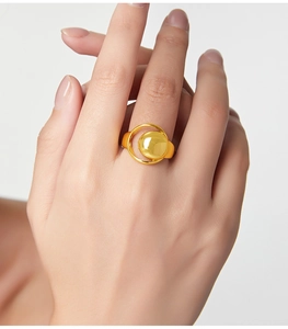 Detail of minimalist gold plated geometric ring featuring a hollow moon crescent design