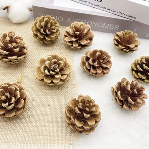 Natural brown pine cones displayed on beige linen and plush fabric for rustic Christmas decor