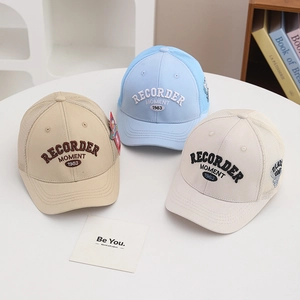 Detailed close-up of breathable trucker hats with vintage embroidery and mesh panels