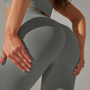 Detail of grey seamless knitted yoga pants showing ribbed texture and lifting effect