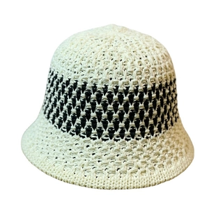 Two-tone crochet bucket hat in cream and black with intricate knit pattern for women