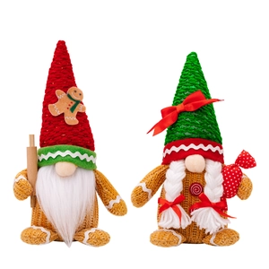 Pair of Christmas gnome plush dolls with gingerbread man hats on white background