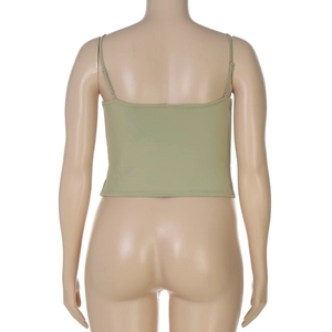 Back view of a cropped grass green camisole on a mannequin showing knit texture