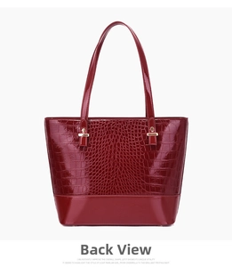Back view of burgundy crocodile pattern tote bag with polished glossy finish and gold hardware