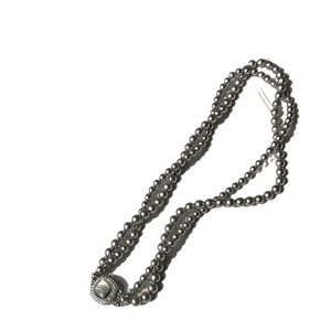 Double-layer grey pearl necklace with a vintage square zircon clasp on white background