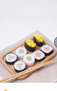 Macro view of a realistic PVC sushi keychain featuring detailed corn and cucumber rolls