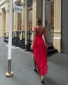 Detail of red backless dress with layered ruffles and elegant slit design on the back