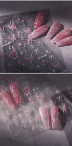 Macro detail of 3D tulip and pink butterfly nail art stickers with gold foil finish