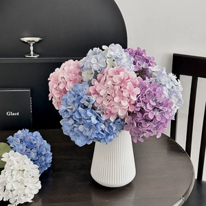 Detailed view of colorful 3D printed hydrangea bouquet in a white textured ceramic vase