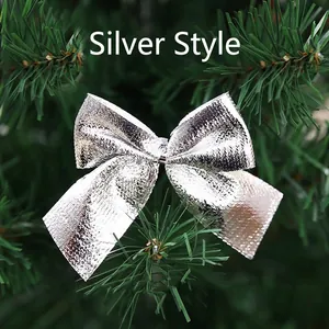 Close-up of silver Christmas bow with honeycomb texture on green pine branches