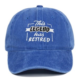 Detail of embroidered 'This Legend Has Retired' text on blue washed cotton baseball cap