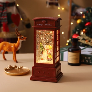 Close-up of a red Christmas telephone booth water lantern with snowman and swirling snow